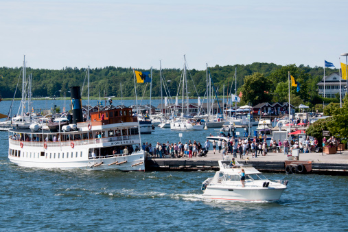 Vaxholm,Sweden - july 27,2012:Tourists arrive by boat to celebrate summer in  Waxholm  in Stockholm archipelago