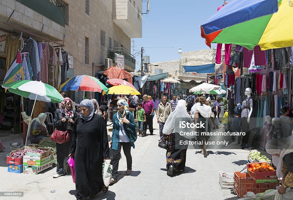 Suq in Bethlehem Bethlehem, Israel - july 28, 2012: market bethlehem, Arab women with typical clothes and tourists strolling to the market of Bethlehem. Bethlehem is a city in the Palestinian territories. All Middle Eastern Flags Stock Photo