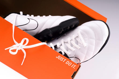 Nova Gorica, Slovenia- January 17, 2013: A new black and white pair, of a Nike indoor soccer shoes in orange packaging, with their traditional slogan.