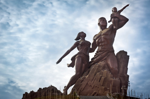 Dakar, Senegal - January 31, 2012: The African Renaissance Monument in the morning. The monument, inaugurated in 2010, consists of a bronze statue located on top on one of the hills outside of Dakar and represents the african family, looking towards the Atlantic Ocean. It's the tallest statue in Africa.