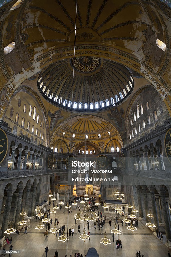 Inside the Aya Sofya Istanbul, Turkey - April, 16 2011: Turkish and foreign tourists in the famous former basilica and mosque, Hagia Sofia, in the Sultanahmet district of Istanbul. The high point of shooting allows you to show the architecture of the basilica. Antiquities Stock Photo