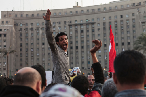 Cairo, Egypt - November 22, 2011: A protestor on Tahrir Sq is demanding removal of the military rule in and all he wants is freedom and peace for Egypt.