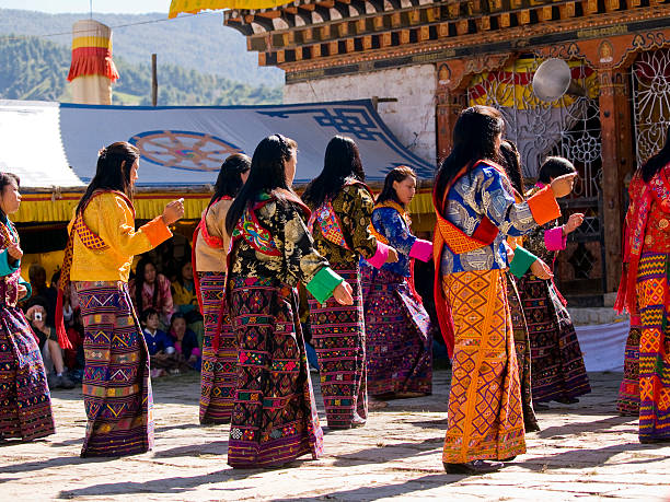 Dancing women wearing traditional kira dresses stock photo