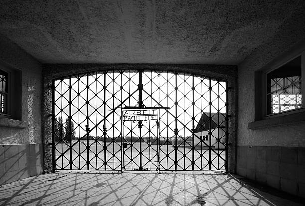 Dachau, Germany- July 7, 2013: Entrance of Dachau concentration camp with the famous words arbeid macht frei. Dachau concentration camp is located about 16 kilometer from Munich. It was the first Nazi concentration camp opened in Germany.