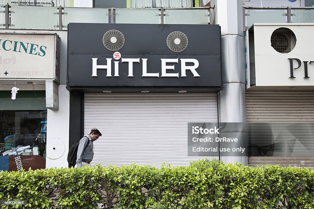 Clothing store "HITLER" in Ahmedabad Ahmedabad, Gujarat, India - August 31, 2012: A man walking past the clothing store 'Hitler' in Ahmedabad. Members of the Jewish community have urged the shop owners to change the name of the store, which was opened on August 19, 2012. Adolf Hitler Stock Photo