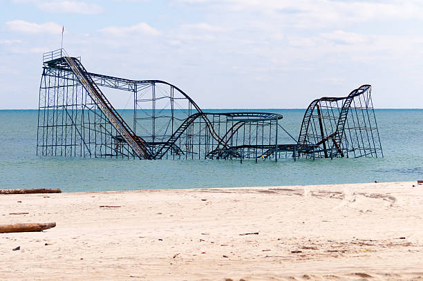 Coaster no more Seaside Heights, NJ USA – March 3rd, 2013. The former JetStar Roller Coaster sits in the ocean, follwing Superstorm Sandy. abandoned roller coaster stock pictures, royalty-free photos & images