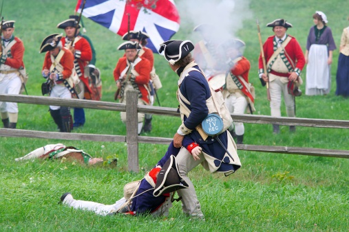 Fredonia, Wisconsin, USA - September 1st, 2012: Revolutionary War reenenactors representing British soldiers charge the American lines