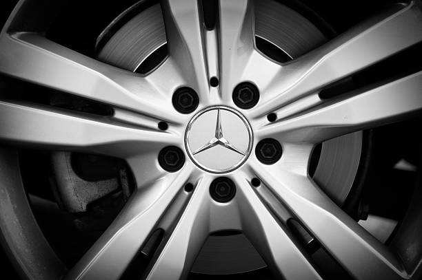 Mercedes wheel Padua, Italy - July 8, 2012: Mercedes-Benz metallic logo on a car rim. Mercedes-Benz (division of Daimler AG) is a German manufacturer of automobiles, buses, coaches, and trucks. It is famous all over the world for high quality, elegant and durable products. Shot in a public parking. mercedes benz photos stock pictures, royalty-free photos & images
