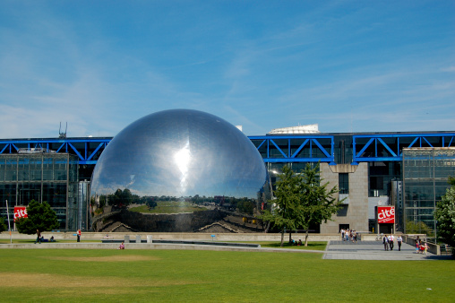 Paris, France - July 24, 2008: On a sunny summer afternoon, visitors exit the Cite des Sciences et de l'Industrie near the Geode, a popular  Omnimax cinema that opened in 1985 in the 10th arrondissement of Paris.