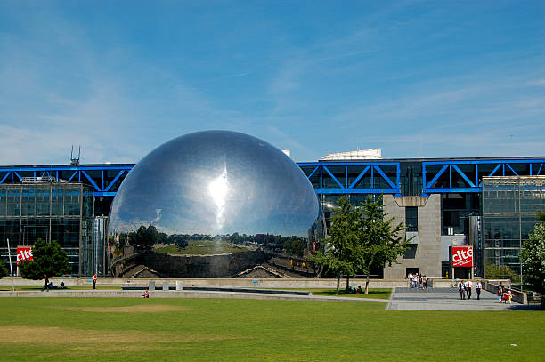 Geode at the Cite des Sciences et de l'Industrie, Paris Paris, France - July 24, 2008: On a sunny summer afternoon, visitors exit the Cite des Sciences et de l'Industrie near the Geode, a popular  Omnimax cinema that opened in 1985 in the 10th arrondissement of Paris. industrie stock pictures, royalty-free photos & images