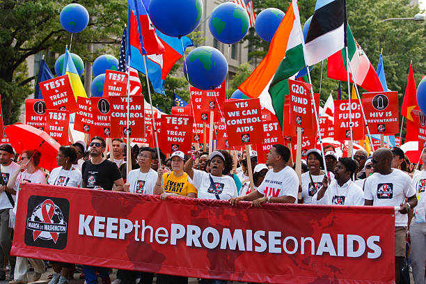 March on Aids in Washington DC Washington DC, USA - July 22, 2012: People Marching on the Capital protesting lack of support for Aids Medical research funding. March on Aids took place on July 22, 2012 in Washington DC aids walk stock pictures, royalty-free photos & images