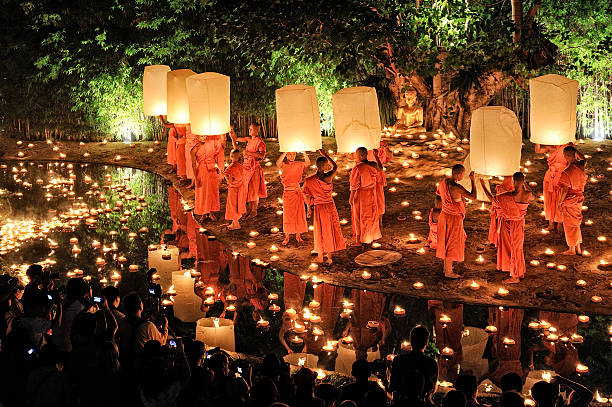 Monks at Phan Tao temple during the Loi Krathong Festival. Chiang Mai, Thailand - November 28, 2012: Traditional monk lights floating balloon made of paper annually at Wat Phan Tao temple during the Loi Krathong Festival. chiang mai province stock pictures, royalty-free photos & images