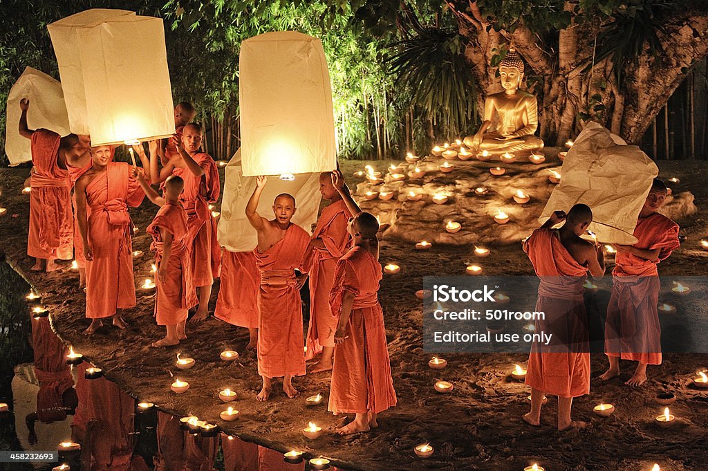 Monks at Phan Tao temple during the Loi Krathong Festival. Chiang Mai, Thailand - November 28, 2012: Traditional monk lights floating balloon made of paper annually at Wat Phan Tao temple during the Loi Krathong Festival. Adulation Stock Photo