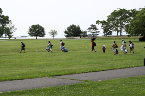 Stamford, USA - June 19, 2011: The individuals are going to the beach at the city Cove Island Park. The park is a popular spot for city residents and of surrounding towns, it offers a one mile loop for biking, walking, children's playground and barbecue areas.