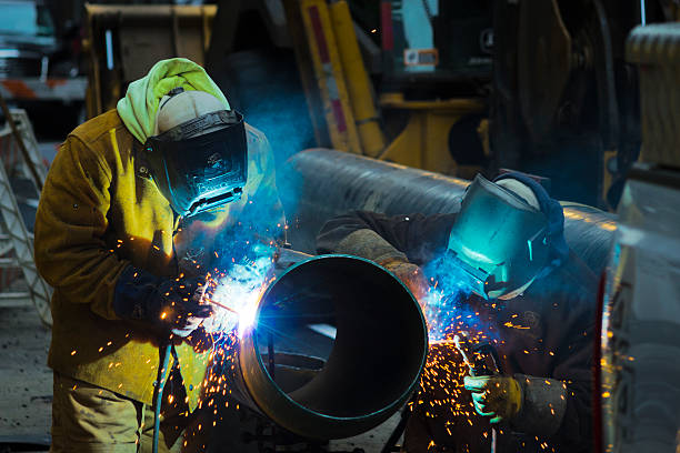 Welders Are Working On A Pipe stock photo