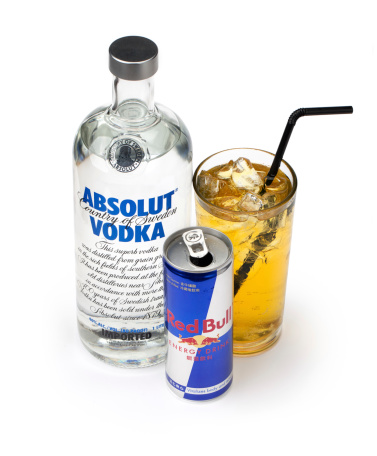 Taipei, Taiwan - September 19, 2012 - This is a studio shot of a vodka Red Bull cocktail taken beside a  bottle of Absolut Vodka and a can of Red Bull on a white background.