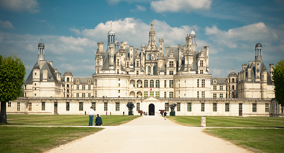 Chambord, France - May 6, 2010: Some tourists walk in front of the majestic castle of Chambord, in the region of Pays de la Loire (France).