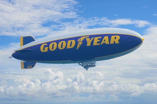 Palm Beach, Florida, USA - September 23, 2012: The Goodyear Blimp makes its way across the Atlantic shore against a beautiful sky. Shot was taken from the 20th floor of a building to capture the eye-level view of the Blimp. Operated by Goodyear Tire and Rubber Company, the Goodyear Blimp is  used for advertising purposes and for aerial views of sporting events.