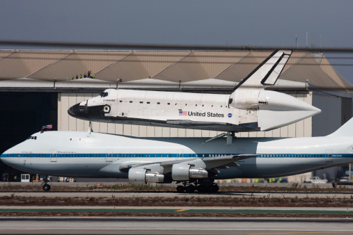 Los Angeles, USA - September 21, 2012: Space Shuttle Endeavour atop the Shuttle Carrier Aircraft lands in Los Angeles, Sept 21, 2012.  The retirement of the shuttle fleet marks an end of an era in American space exploration.