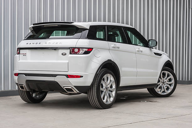 range rover evoque 2012 backside view ChiangMai,Thailand - August 6, 2012: A photo of a parked White 2012 range rover evoque 2012 on display outside of a car dealership in Thailand evoque stock pictures, royalty-free photos & images