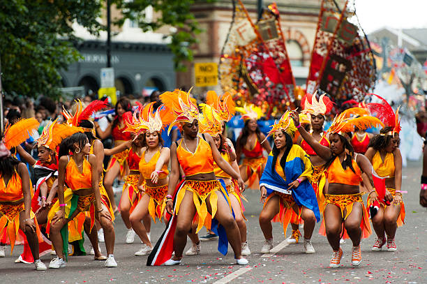 Dancers at Notting Hill Carnival London, UK - August 27, 2012: Dancers performing at the Notting Hill Carnival in Notting Hill, West London on 27th August 2012. notting hill carnival dancers stock pictures, royalty-free photos & images
