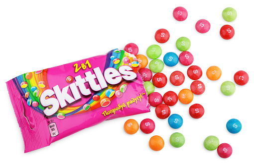 Tula, Russia - December 18, 2012: Closeup of unwrapped Skittles candy made by Wm. Wrigley Jr. Company isolated on white background with clipping path