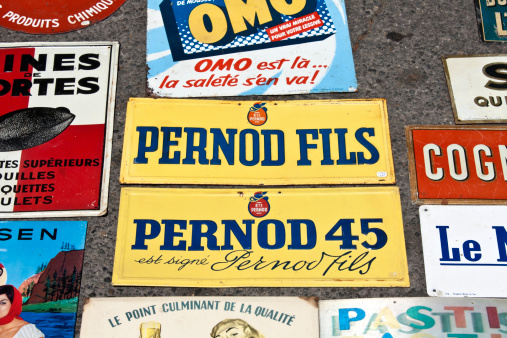 L'Isle sur la Sorgue, France - July 28, 2012 : Vintage advertising signs on sale at L'Isle sur la Sorgue market