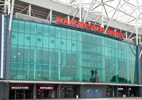 Manchester, England - September 3, 2012: The east stand of Old Trafford football stadium, home of Manchester United. With a capacity of 76,000 spectators, Old Trafford is the second largest stadium of any English football ground.