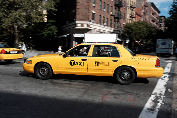 Taxi Billboard in Chelsea, NYC New York, Usa - Sep 18th, 2010: New York Taxi driving in Chelsea, Manhattan, NYC. With antique buildings on the background. yellow taxi cab stock pictures, royalty-free photos & images