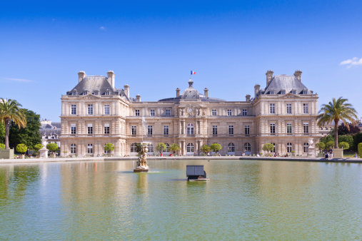 Paris, France - June 30, 2012: Palais du Luxembourg. The Palais is situated in the Jardin du Luxembourg (Luxembourg Garden) in the Latin Quarter.  The palace was built between 1615 and 1627 for Marie de' Medici. The building currently houses the French Senate. The Jardin du Luxembourg is probably the most popular park in Paris. Tourists are walking around the garden.