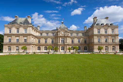 Paris, France - June 30, 2012: Palais du Luxembourg. The Palais is situated in the Jardin du Luxembourg (Luxembourg Garden) in the Latin Quarter.  The palace was built between 1615 and 1627 for Marie de' Medici. The building currently houses the French Senate. The Jardin du Luxembourg is probably the most popular park in Paris. Tourists and parisians are relaxing in chairs and admiring the palace.