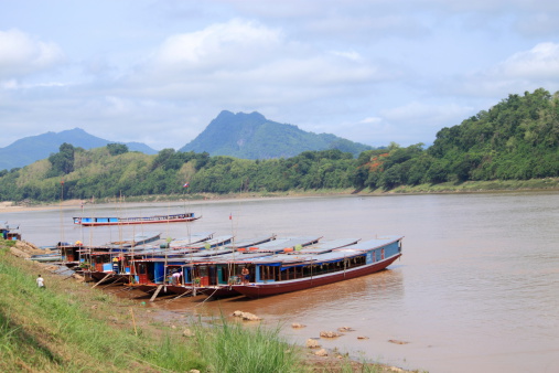 Luang Prabang Laos - May 16,2010: Local people cleaning a boat, Mekong river in Luang Prabang Laos