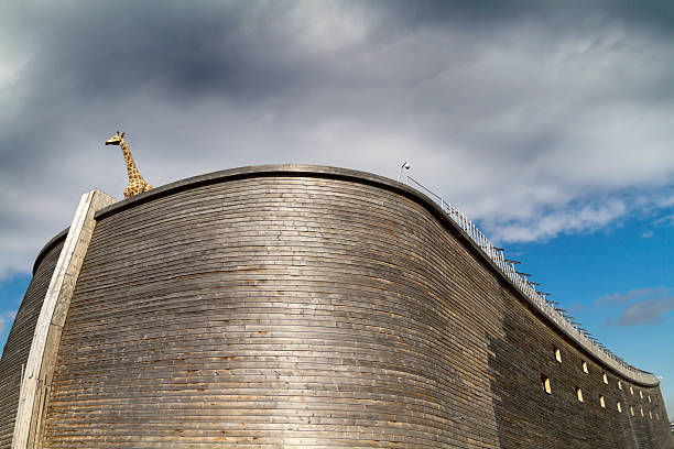 Close up of Noah’s Ark and giraffe Dordrecht, The Netherlands - March 18, 2013: Just completed full-sized replica of Noah’s Ark and imitation giraffe standing on deck under oncoming storm clouds. This is John Huibers’, a famous Dutch building contractor, second ark; the first one, a half-sized replica was finished in 2007. named animal stock pictures, royalty-free photos & images