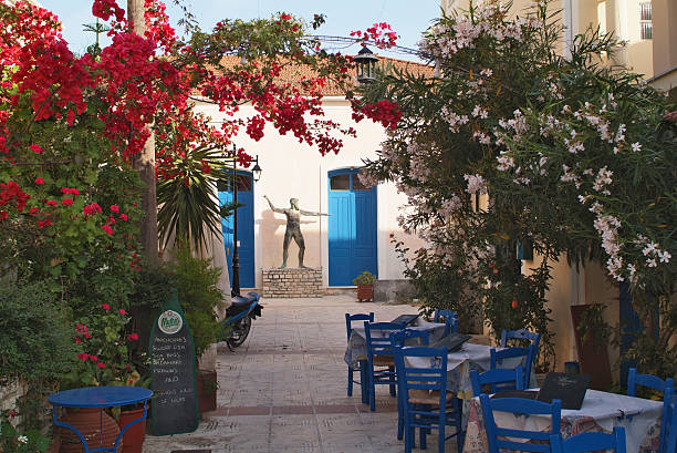 Greece, Ithaca Vathi, Greece - May 23rd 2006: Restaurant and sculpture of an ancient Greek warrior in Vathi, the island is generally identified with Homer's Ithaca, the home of legendary Odysseus ithaca stock pictures, royalty-free photos & images