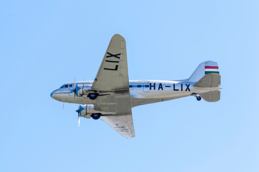Budapest, Hungary - August 20, 2012: Lisunov Li-2 airplane (soviet copy of the famous DC-3) with historical painting over Danube river, during the Air Parade.