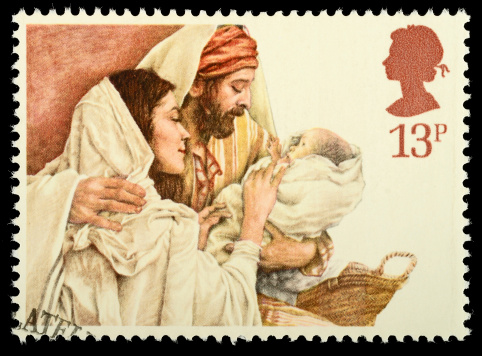 Exeter, United Kingdom - October 16, 2011: British Used Christmas Postage Stamp showing Mary, Joseph and Baby Jesus in religious nativity scene, printed and issued in 1984