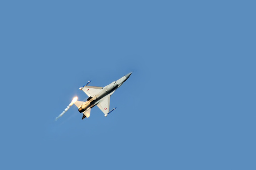 Batajnica, Serbia - September 2, 2012: : Royal Danish Air Force F16 fighter plane releasing infrared countermeasure decoy during celebration of 100 years of Serbian Air force in Batajnica, Serbia on september 2, 2012.