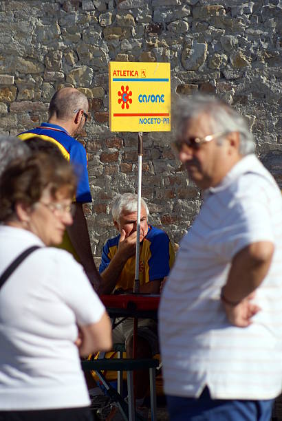 Country march Bastelli, Parma, Italy - July 18, 2009: Runners and spectators are preparing for the fourth edition of the "March of Fountains" a march in memory of Michele Rossi, in Bastelli. gruppo sportivo stock pictures, royalty-free photos & images