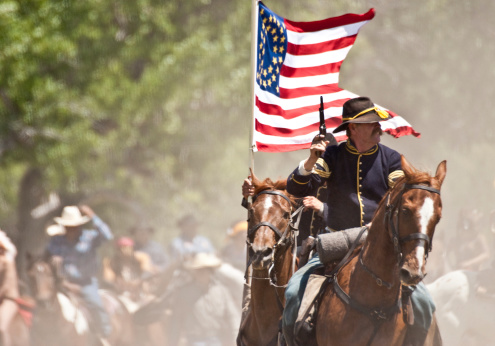 Crow Agency, Montana USA - June 27, 2009: Members of the U.S. Cavalry School reenact the Battle of the Little Bighorn, also know as Custer's Last Stand on the site of the famous 1876 massacre of the U.S. Armyaas 7th Cavalry by Lakota, Northern Cheyenne and Arapahoe Indian tribes. The reenactment is put on by the Real Bird family and U.S. Cavalry School.