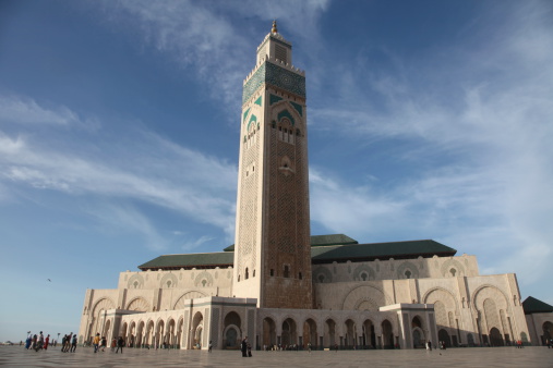 Casablanca, Morocco - October 23, 2013: The Mosque of Hassan II and random people walking in front of it.