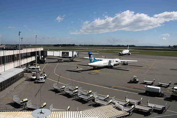 Christchurch, New Zealand - March 18, 2008: People work in airport apron on March 18, 2008 at Christchurch International Airport. The airport opened a new domestic terminal in early 2011.