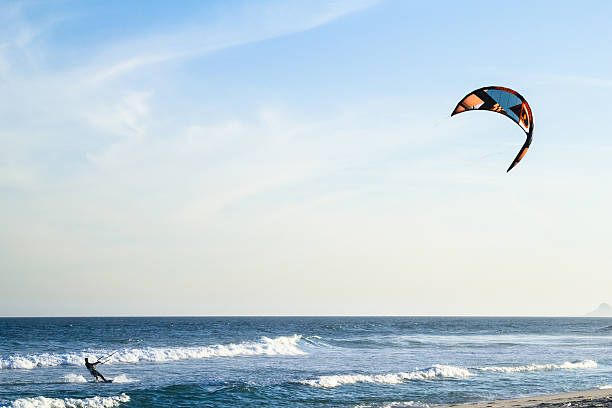 Kite surf Rio de Janeiro, Brazil - August 08, 2013: Man practicing kite surf at Praia da Barra (Barra beach), a traditional spot for this sport. The heavy winds make this place perfect for it. barra beach stock pictures, royalty-free photos & images