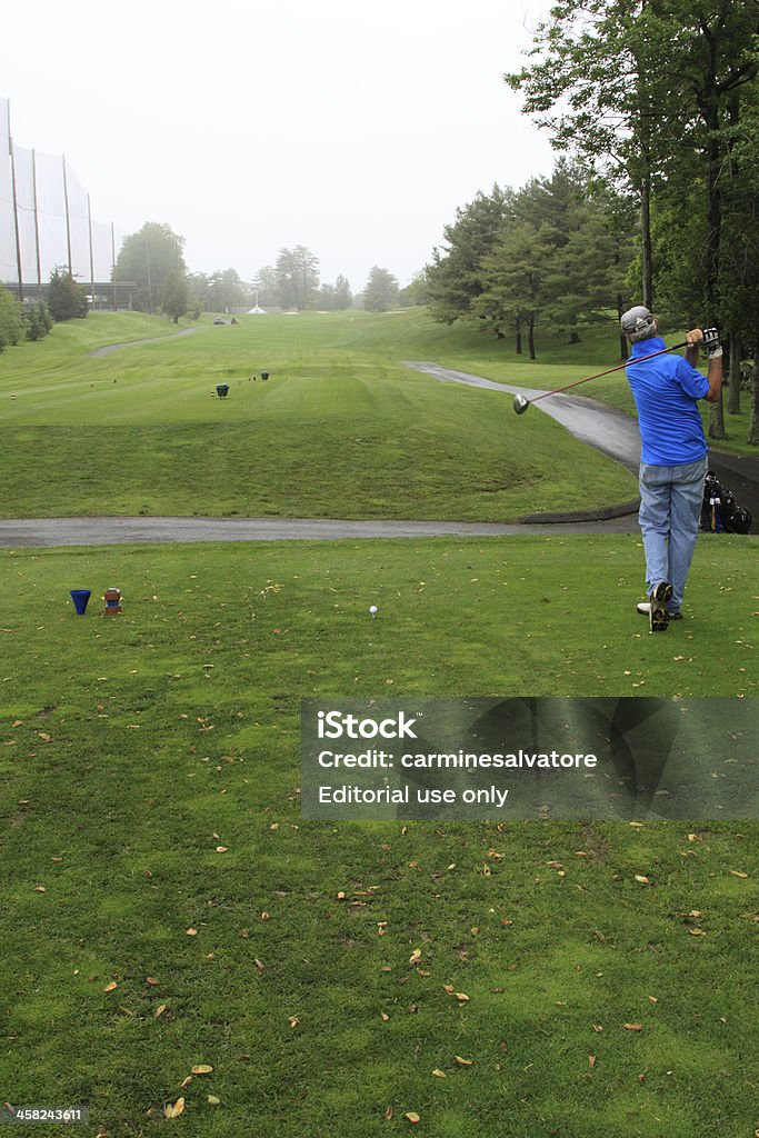 practice swing Stamford, USA - May 25, 2012: Man taking a prctice golf swing at Sterling Farms. Sterling Farms is an 18 hole, par 72, public course laid out over 144 acres of a once active dairy farm. Originally designed by Architect Geoffret Cornish in 1969. The facility gets rated #1 public golf course if Fairfield county year after year. Adult Stock Photo