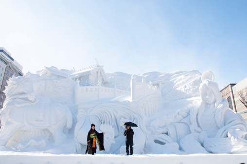 Sapporo, Japan - February 9 2013 : Snow sculpture of Ise ~ Trip to the Myths at Sapporo Snow Festival 2013 in Sapporo, Hokkaido, Japan. Two Japanese singers are on the stage singing traditional japanese songs. The Festival is held at Sapporo Odori Park. The festival is one of Japan's largest winter events, attracts a growing number of visitors from Japan and abroad every year.
