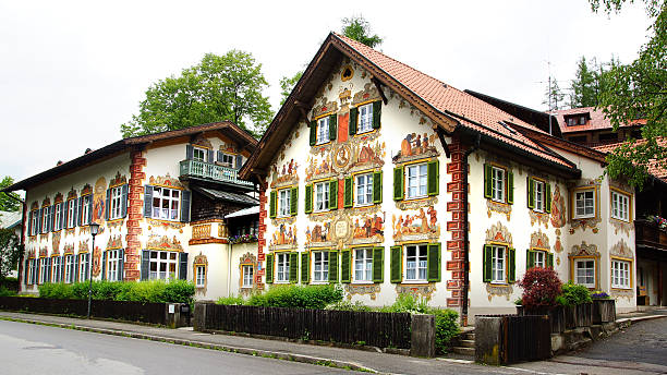 Oberammergau, Germany -June 09, 2012: Unique Fairy tale house on  Ettaler Strasse. Oberammergau is famous for its Luftlmalerei, or frescoes, of traditional Bavarian themes, fairy tales, religious scenes. Some of the houses are painted with scenes from Little Red Riding Hood and ect; Oberammergau, Germany