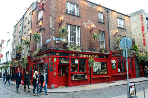 Dublin, Ireland,  April 1, 2013: The Temple Bar, famous pub named after the surrounding area, daytime, young people walking along.