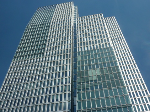 Dusseldorf, Germany - July 16th, 2022: High skyscraper Dreischeibenhaus from Thyssenkrupp in Düsseldorf as tall building in summer as contemporary architecture and clean glass facade blue sky clouds