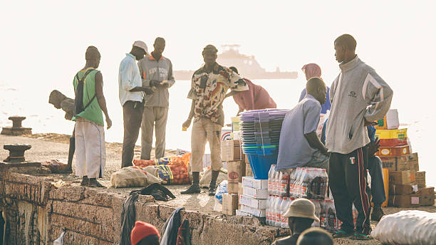 African market. Barra, The Gambia, 3rd March 2011: Local people trading different goods on river port.  This main crossing point over river Gambia to capital city Banjul a is always busy. banjul stock pictures, royalty-free photos & images