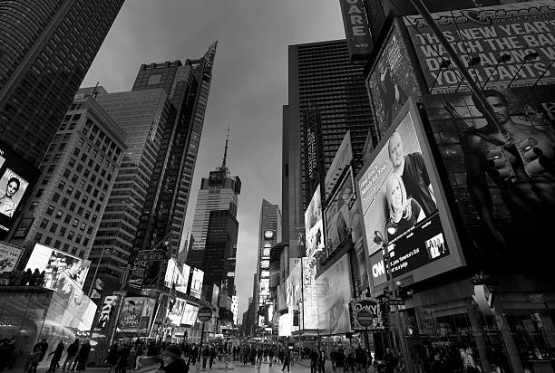 New York City, USA - February 24, 2013: Wide angle view of Times Square by night with illuminated billboards and crowds of people