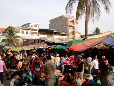 Phnom Penh, Cambodia - February 18, 2008: market vendors and busy ambient outside the Russian market in Phnom Penh, Cambodia.The Russian market is a popular spot for tourists and local people who can find every sort of food, handicrafts, textiles, souvenirs and every weird accessories.